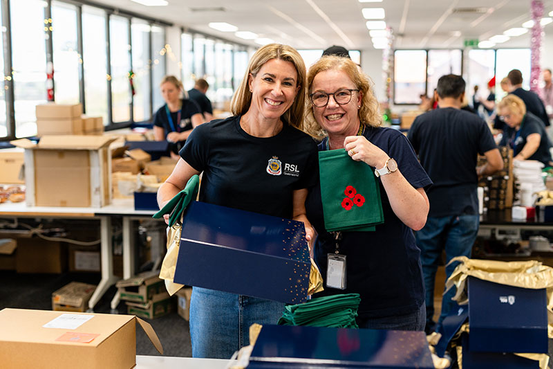 RSL Queensland staff members pack Christmas Hampers with Sacha de Wit's towels.