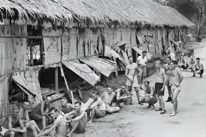 Members of 2/29th Battalion outside their hut in the Changi Prison Camp, 1945