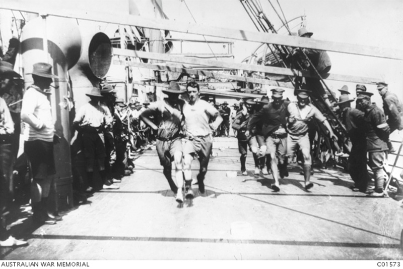 Members of the Australian Imperial Force (AIF) participate in a three-legged race aboard the SS Port Nicholson in 1916.