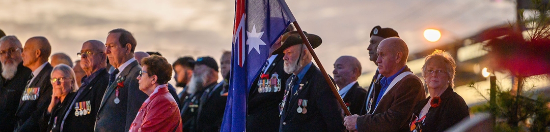 Current serving, veterans and partners standing together at an ANZAC Day Dawn Service