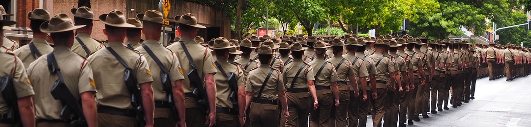Army personnel lined up walking in a march