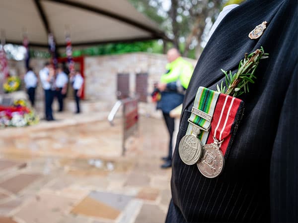 War medals with rosemary pinned to a suit jacket
